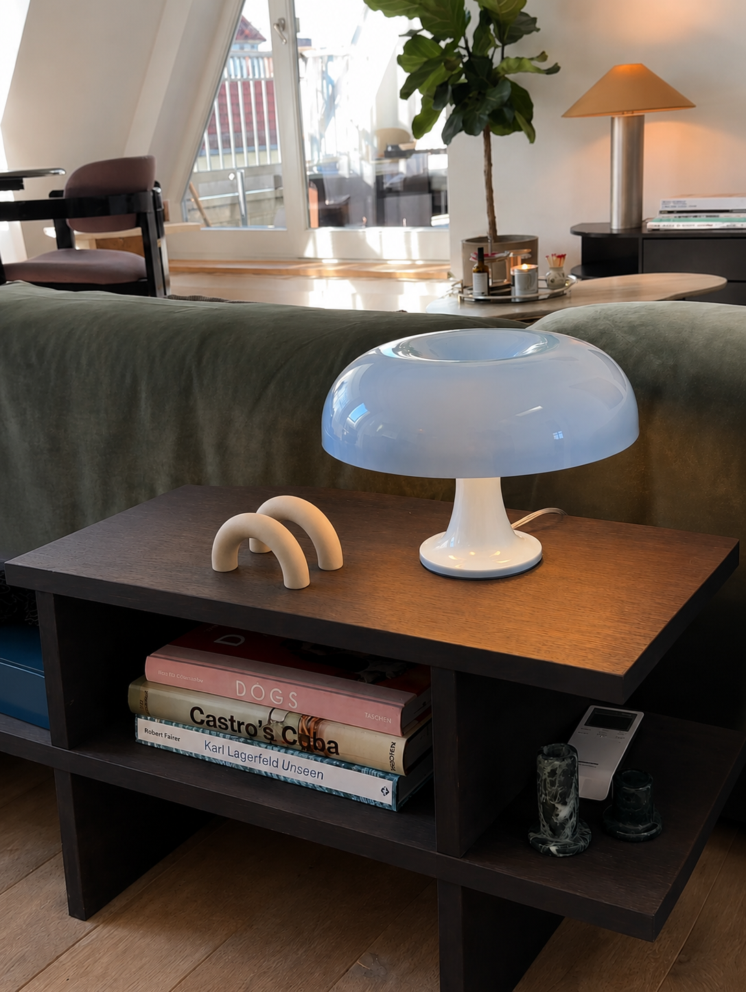 The Arc beside a mushroom lamp on a living room side table